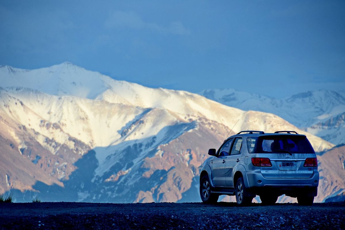 VIP private remise vehicle in front of the snowy Andes mountains in Mendoza